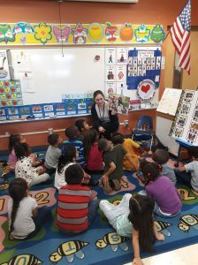 Coral Vargas Reading to Children in a Local School Classroom
